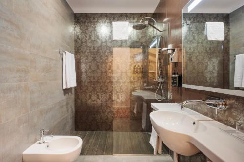 a bathroom with two sinks and a shower at Eurostars Palazzo Zichy in Budapest