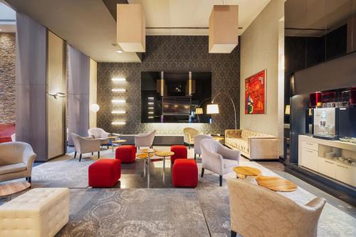 a living room with red chairs and a couch at Eurostars Palazzo Zichy in Budapest