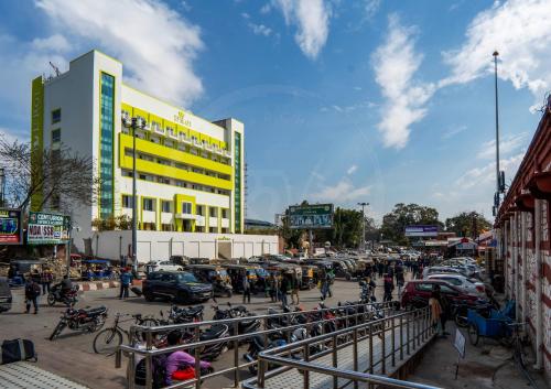 a group of people walking around in a parking lot at Le Roi Dehradun at Dehradun Railway Station in Dehradun