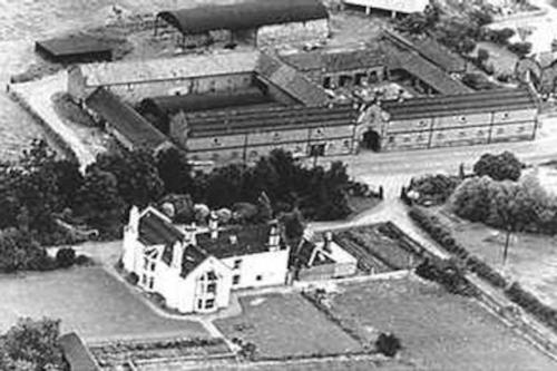 a black and white photo of a large building at Greystoke Mews in Woodborough