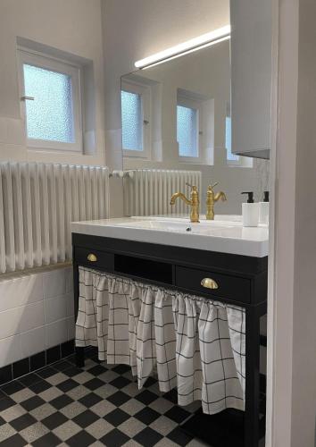 a bathroom with a sink and a mirror at The cozy family Retreat Lübeck in Lübeck