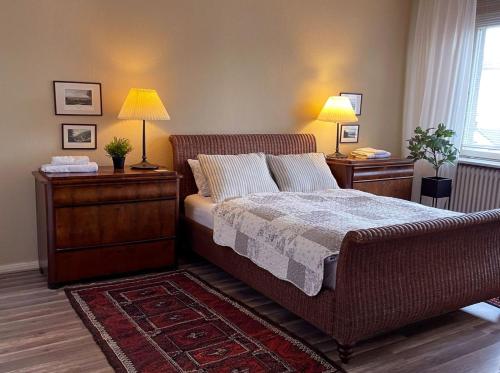 a bedroom with a bed with two night stands and two lamps at The cozy family Retreat Lübeck in Lübeck