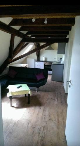 a living room with a couch and a table at Jakobshof in Freckenfeld