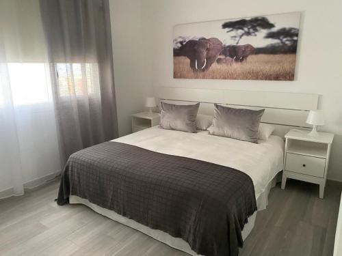 a bedroom with a bed and a picture of elephants at Casa Bagacera "Cera" in Ingenio