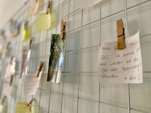 a piece of paper on a tiled wall with notes at Zzz Ijen Hostel in Banyuwangi