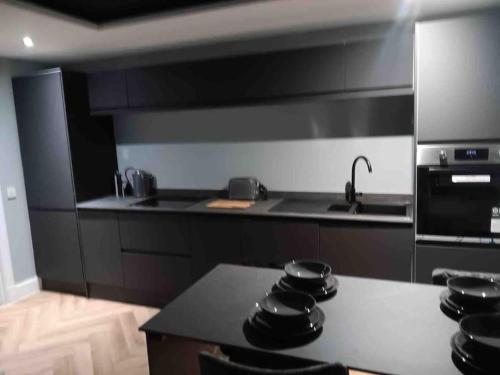 a kitchen with a stove and a counter top at Murrayfield Stadium Basement - 3 Bed 3 Bath in Edinburgh