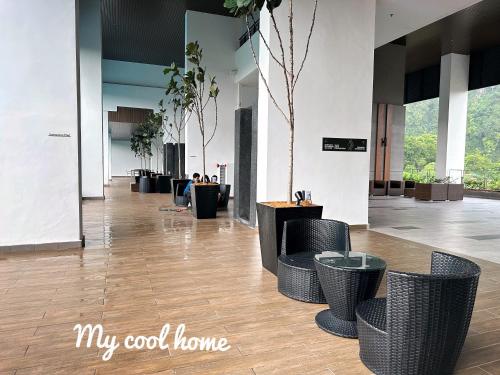 a lobby with chairs and tables in a building at Sunway Onsen Suite Theme Park View Top Floor at Lost World in Tambun