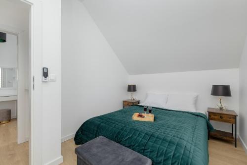 1 dormitorio con 1 cama con manta verde en Apartment with Garden 450 m to the Beach by Rent like home, en Dziwnówek