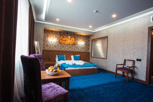 a hotel room with a bed and a table at CASPIAN BUSINESS HOTEL in Baku