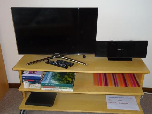 a computer monitor sitting on top of a desk at Ferienwohnung Inauen in Appenzell