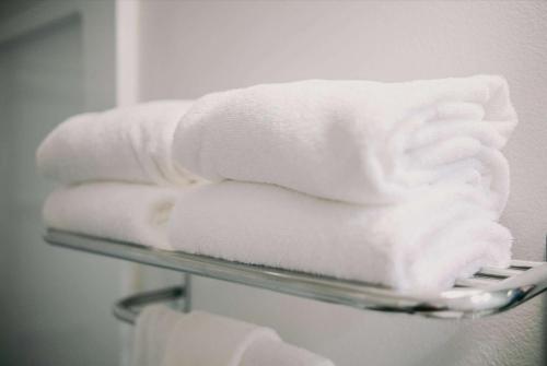 a stack of towels on a towel rack in a bathroom at Baymont INN & Suites by Wyndham in Bellingham