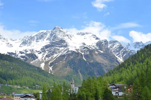 a snow covered mountain with a town in front of it at Haus Lena in Solda