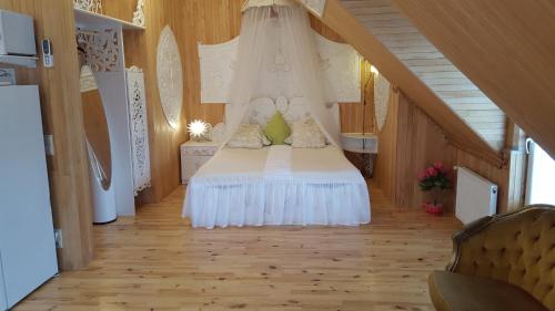 a bedroom with a bed with a canopy at Naiza Guesthouse and Apartments in Jūrmala