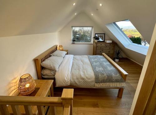 a bedroom with a large bed and a window at Peacock cottage in Ewenny