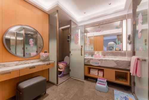 a bathroom with a sink and a mirror at Wyndham Grand Zhaoqing Downtown in Zhaoqing