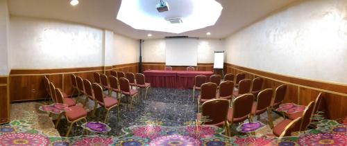 a room with chairs and a table in it at Hotel Meeting in Ciampino