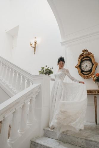 a woman in a wedding dress standing on a staircase at Villa De Cillis Carafa in Torre del Greco