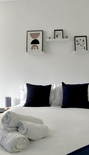 a bedroom with a white bed with towels on it at Legion House Apartment One Middlesbrough in Middlesbrough