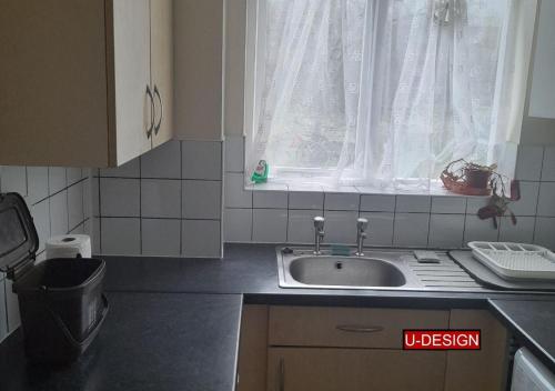 a small kitchen with a sink and a window at E17 - Stay Another Day at our Apartment - Sleeps up to 4 and Free Parking in London