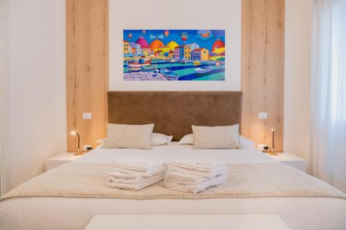 a bedroom with a bed with two towels on it at Lo Studio di viale Lo Re camere & caffe’ in Lecce
