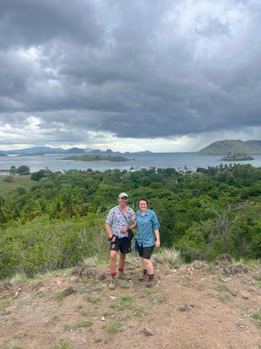two men standing on top of a hill at Jhuna Komodo Homestay in Komodo