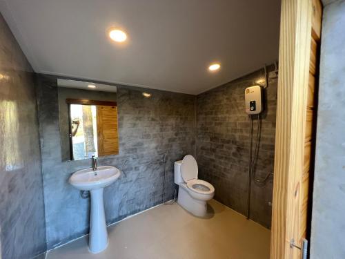 a bathroom with a toilet and a sink at Pang Long Chao resort in Trang