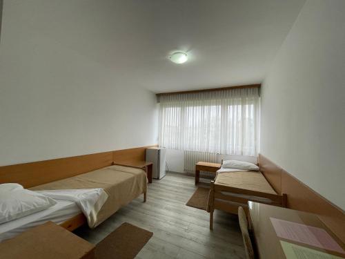 a hospital room with two beds and a window at Hostel Arena in Zagreb