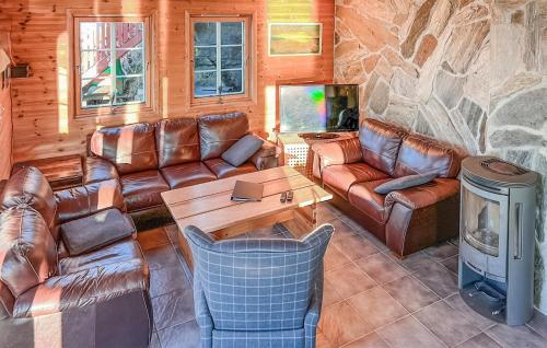 SjernarøyにあるNice Apartment In Sjernarøyの石壁のリビングルーム(革製家具付)
