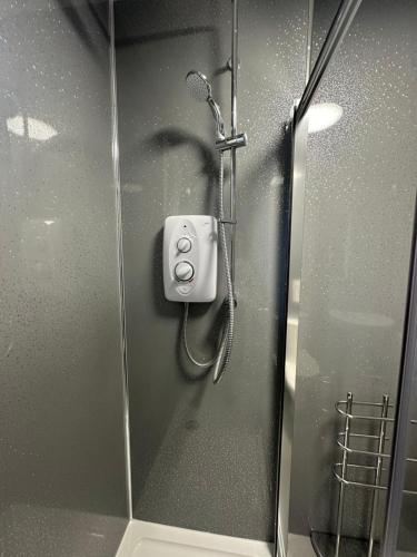 a shower in a bathroom with a glass door at The 1645 Inn in Nairn