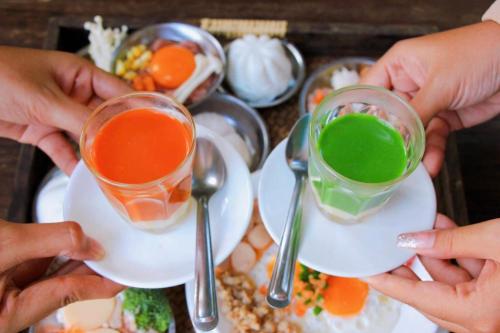 a group of people holding up glasses of different colored liquids at กอบสุข รีสอร์ท2 k15 in Ban Ton Liang