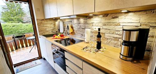 a kitchen with a counter with a bottle of wine at Oskar im Bärenhüsli in Titisee-Neustadt