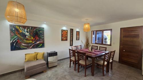 a dining room with a table and chairs and a couch at El cielo en Purmamarca Duplex 3 in Purmamarca