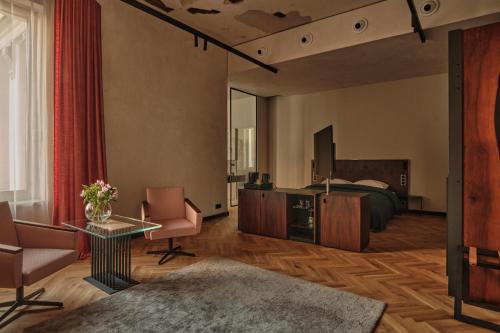 a hotel room with a bed and a table and chairs at Grand Hotel in Łódź