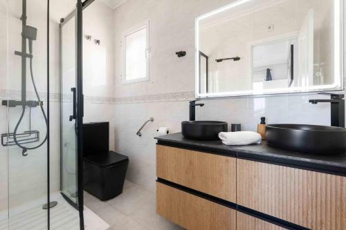 a bathroom with two sinks and a glass shower at HE Paola 2 in Orihuela Costa