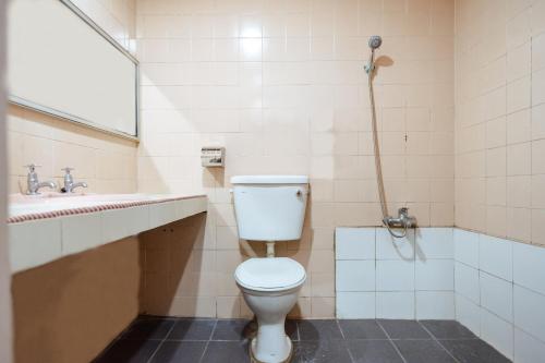 a bathroom with a toilet and a sink at OYO 90208 Milion Inn in Miri