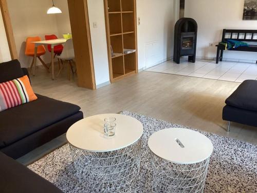 a living room with two tables and a couch at Apartment in Thuringia in Rettenberg