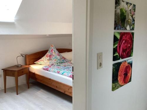 a small bedroom with a bed and a table at Apartment in Thuringia in Rettenberg