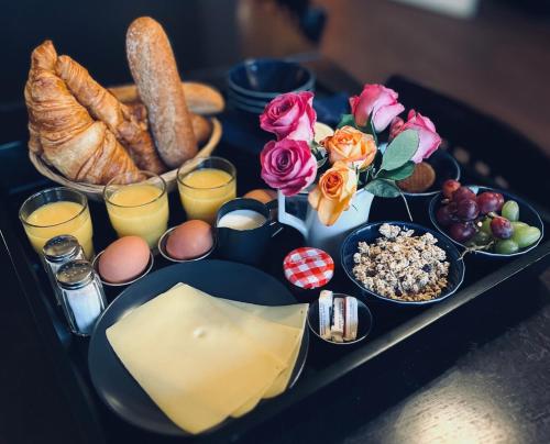 a tray of food with breakfast foods on a table at Hotel Prinsenhof Amsterdam in Amsterdam