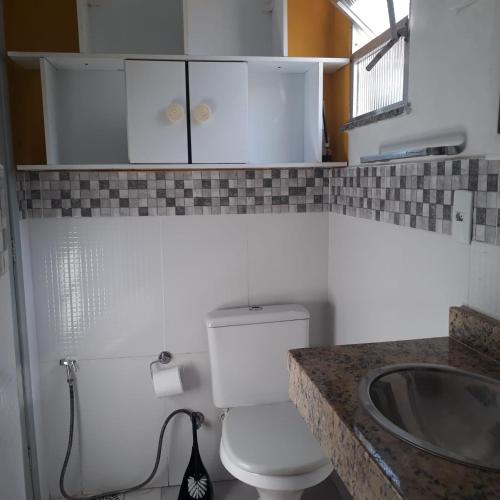 a bathroom with a toilet and a sink at Andrade 2 in Rio de Janeiro