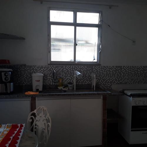 a kitchen with a sink and a window at Andrade 2 in Rio de Janeiro