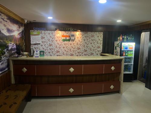 a bar in a restaurant with a counter and a refrigerator at HOTEL ROYAL PARK in Mangalore