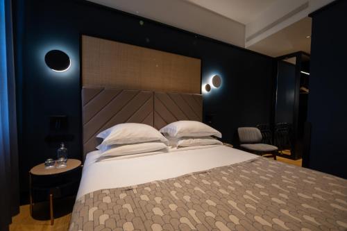 a bedroom with a large bed with a wooden headboard at Axis Porto Club Aliados in Porto