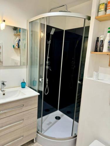 une douche avec une porte vitrée dans une salle de bain dans l'établissement L'escapade Toulonnaise, à Toulon
