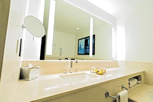 a bathroom with a sink and a large mirror at Hilton Tangier Al Houara Resort & Spa in Al Houara