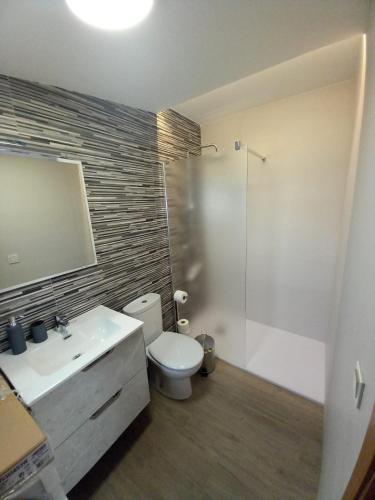 a bathroom with a toilet and a sink and a shower at Los Pinos Munera in Munera