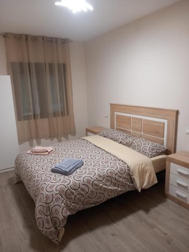 a bedroom with a large bed and a dresser at Los Pinos Munera in Munera