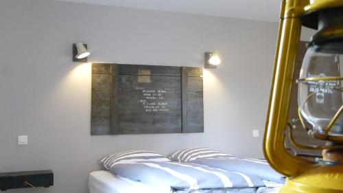 a room with three pillows and a sign on the wall at L’Été en Novembre in Kirrwiller