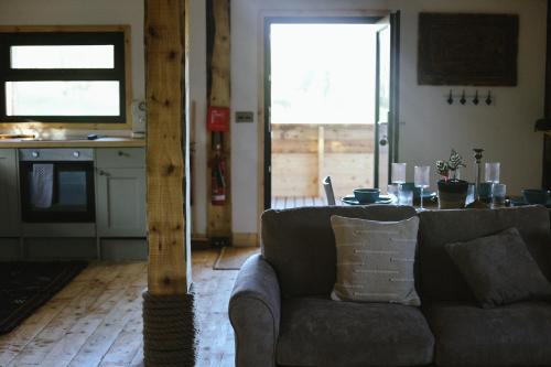 a living room with a couch and a table at Tempo Manor Cabins in Tempo