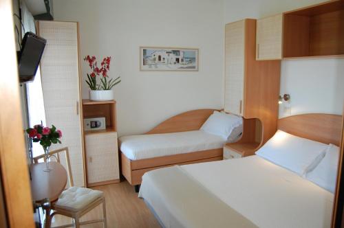 Postel nebo postele na pokoji v ubytování Hotel Rivazzurra