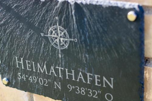 a sign with the name of a ship on it at Heimathafen Langballigholz in Langballigholz